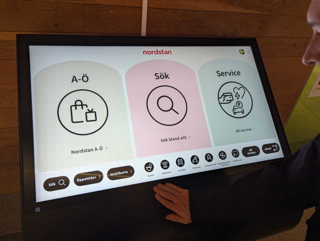 Self service touch screen terminal in shopping mall with way finder and information.